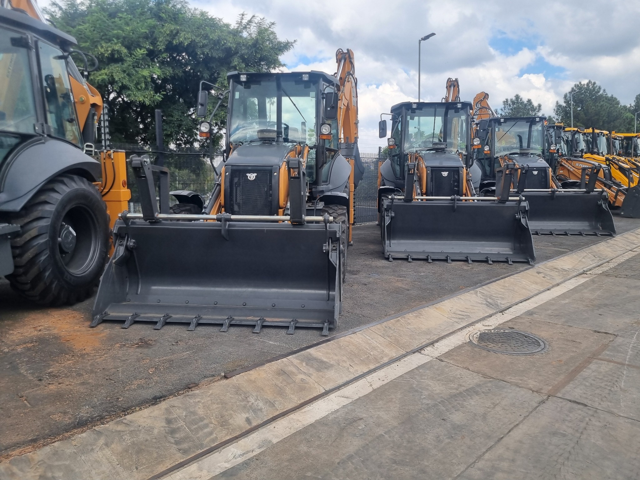 Backhoe loaders lined up for sale